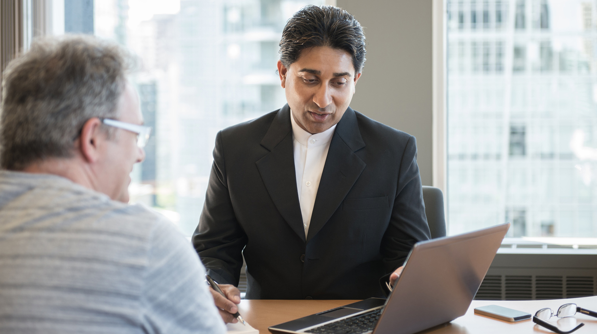 Indian Financial Advisor Showing Information to Client on Laptop Computer