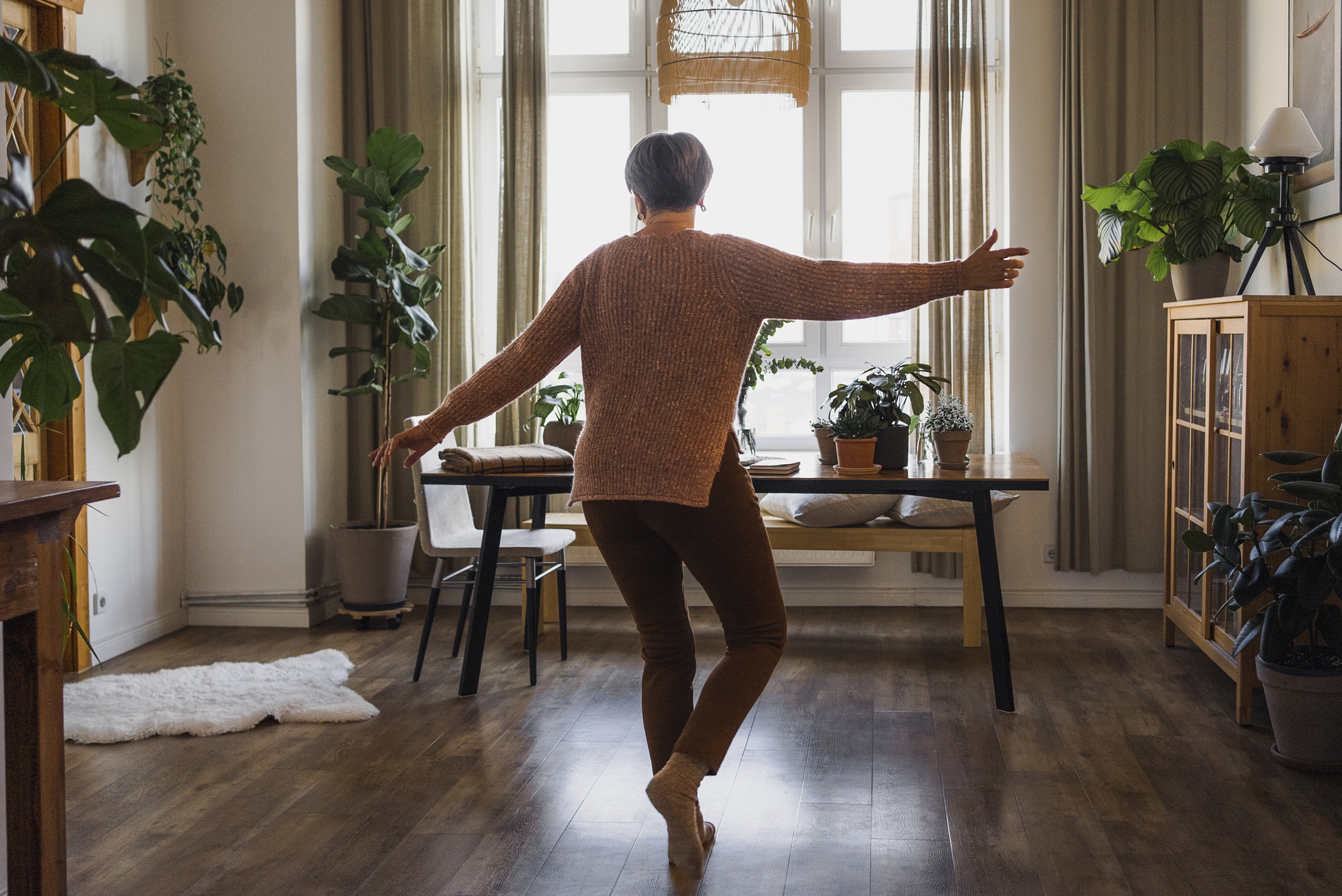 Vrouw danst in de huiskamer