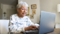 oudere vrouw typt op laptop