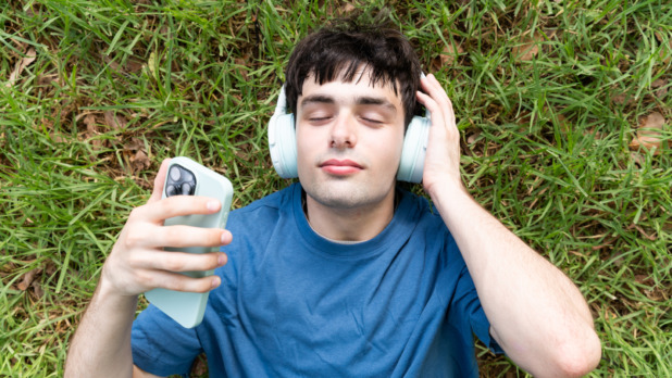 Man met koptelefoon in het park