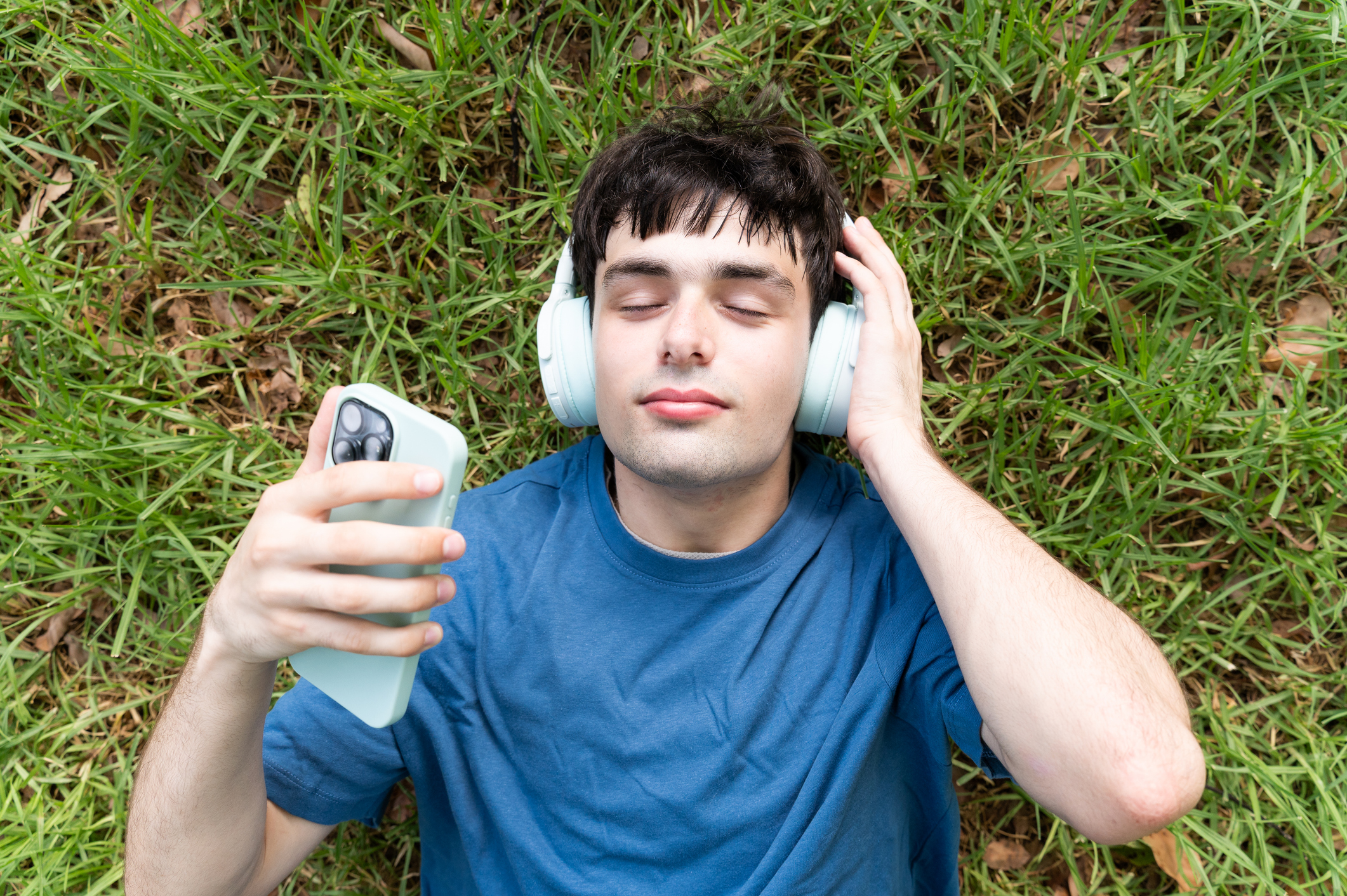 Man met koptelefoon in het park