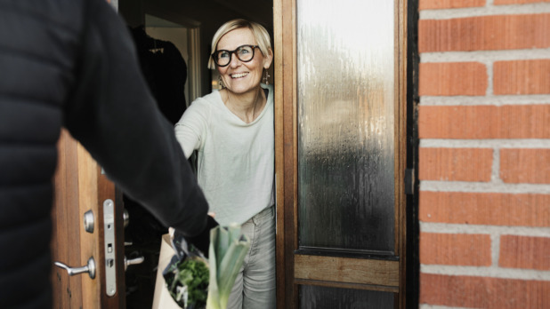 oudere vrouw krijgt boodschappen bezorgd