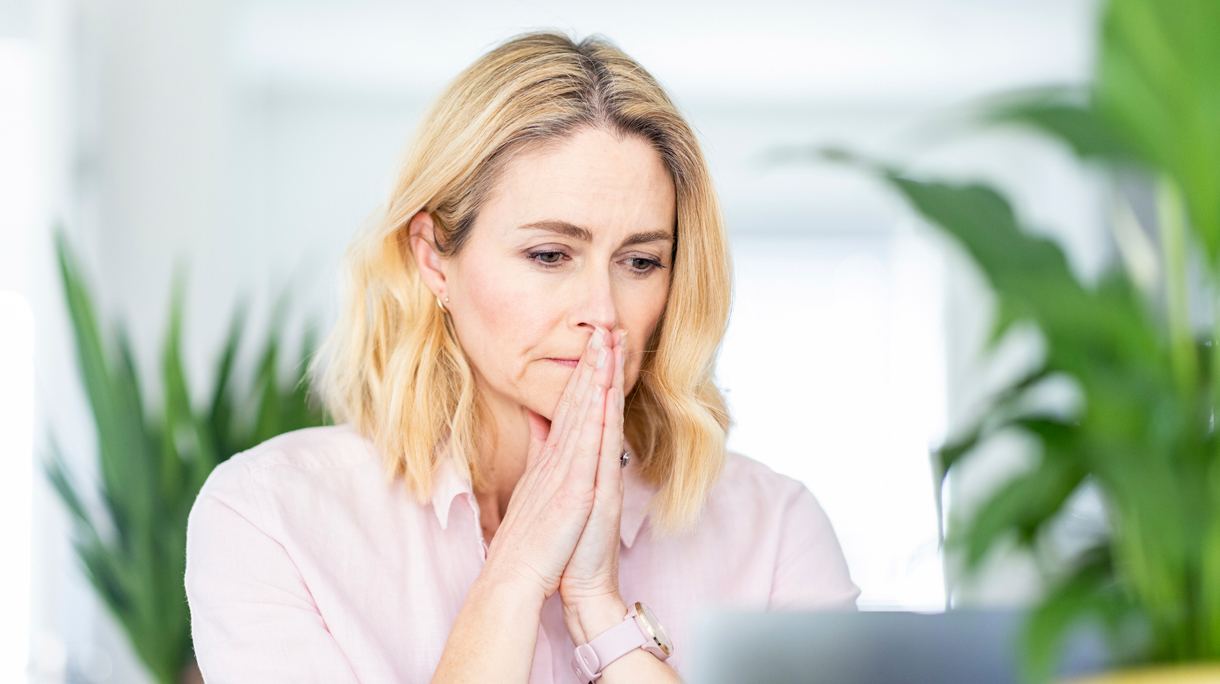 Vrouw bezorgd achter computer, zal ik inloggen of niet?