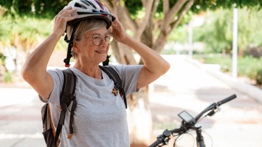 Vrouw zet fietshelm op voordat ze weer op de e-bike stapt