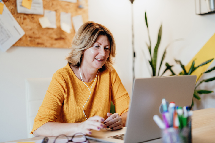 Vrouw zit achter haar laptop te lezen