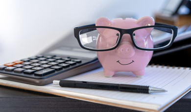 Close-Up Of Piggy Bank On Book