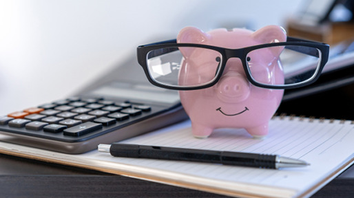 Close-Up Of Piggy Bank On Book