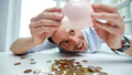 businessman with piggy bank and coins at office