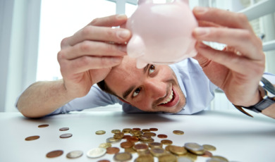 businessman with piggy bank and coins at office