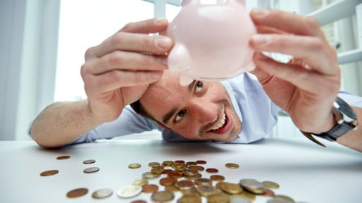 businessman with piggy bank and coins at office